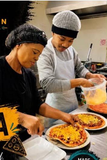 Lee’s Kitchen team preparing freshly topped pizzas in the kitchen